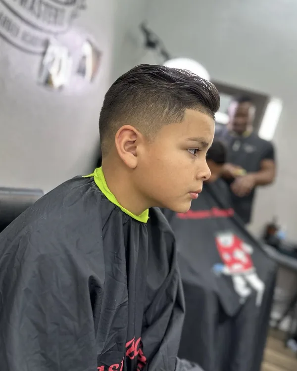 A young client's haircut in progress at a station