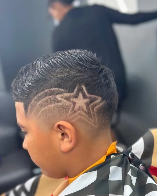 A star design cut into a young client's fade