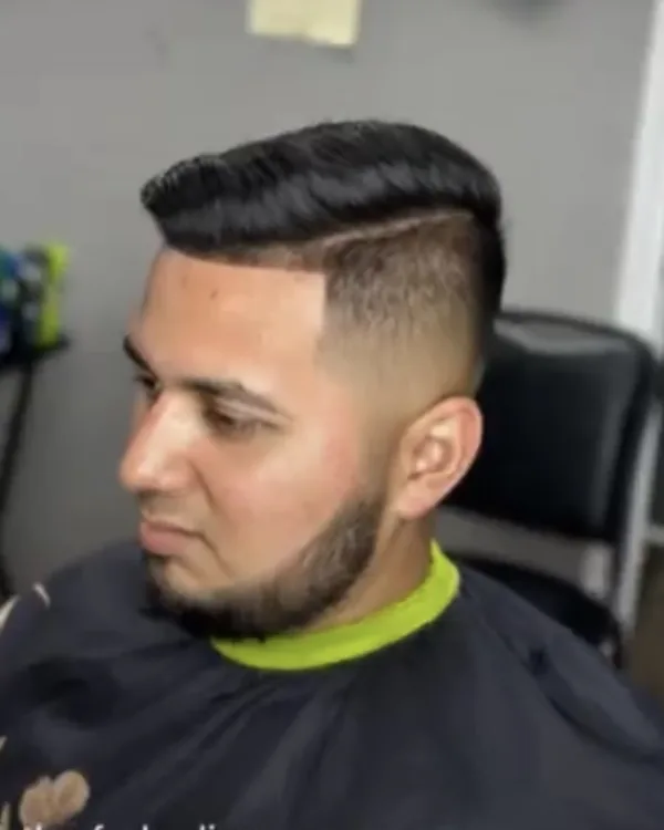 A clean taper on a client in a black cape